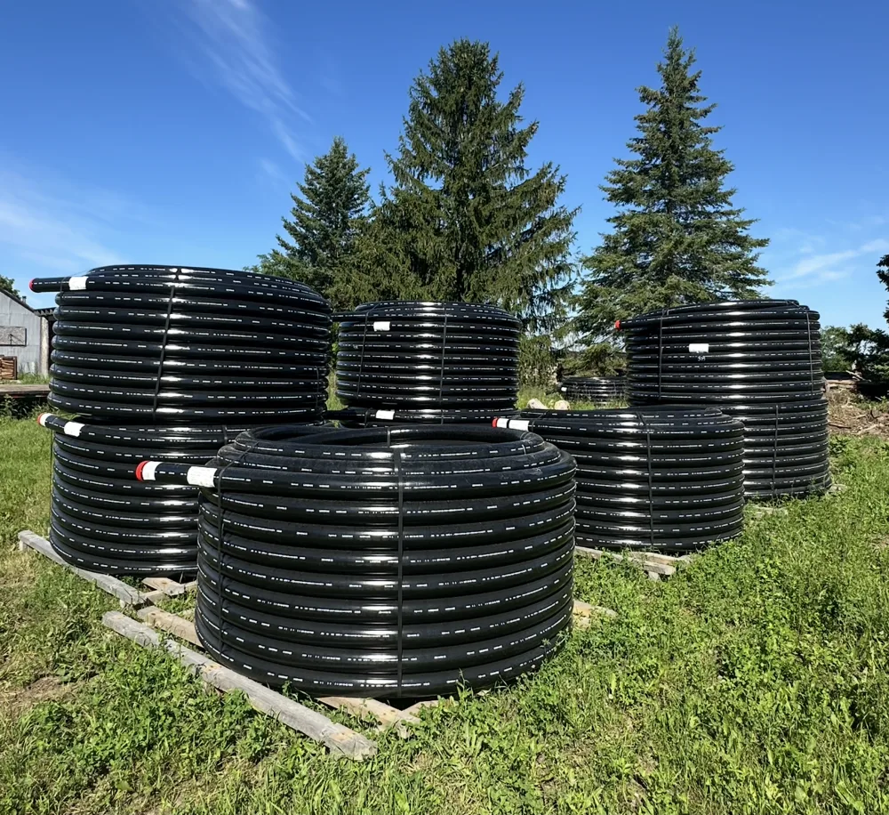 Coils of insulated underground pipe on pallets