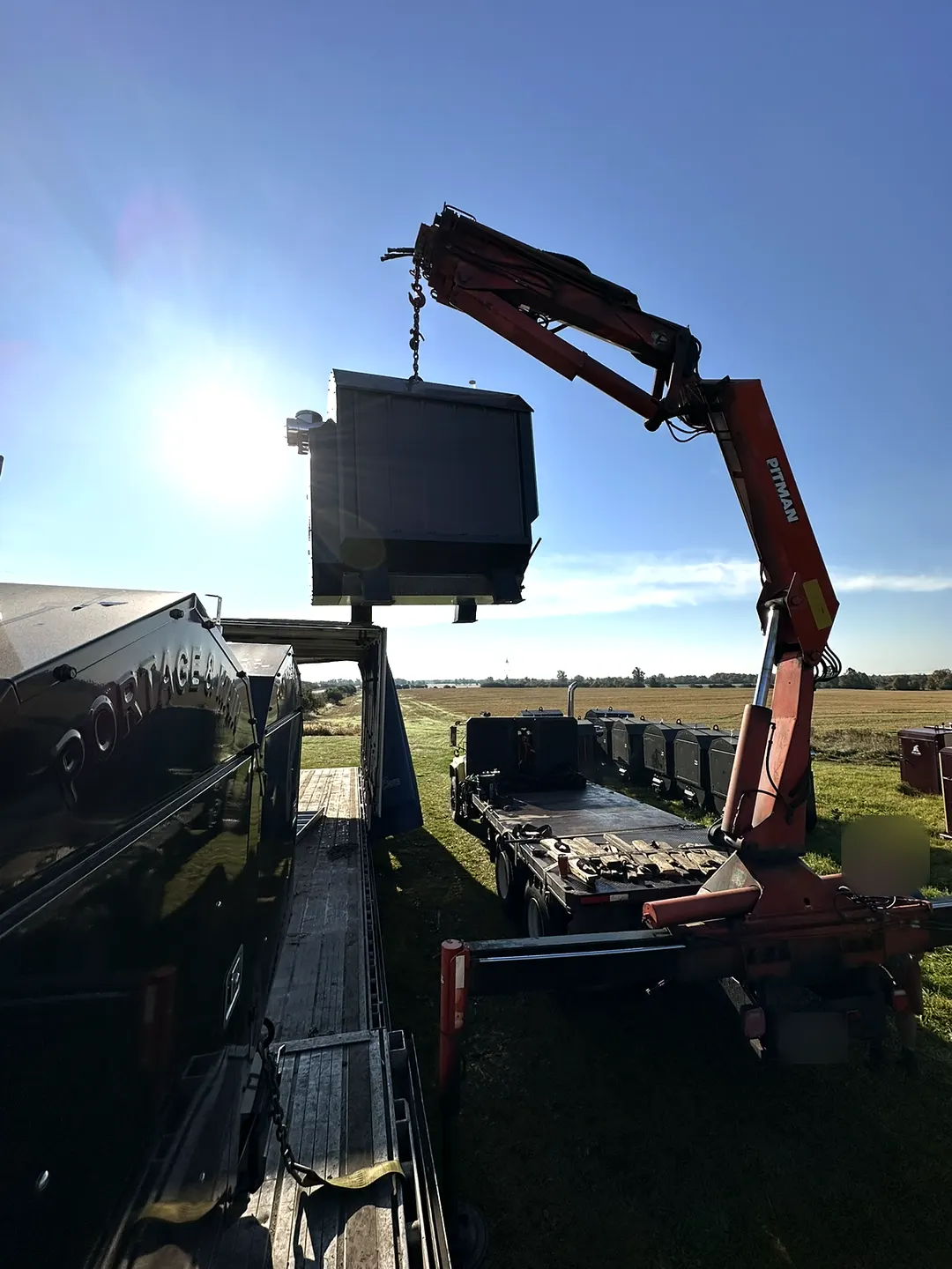 Unloading boilers off the truck by crane